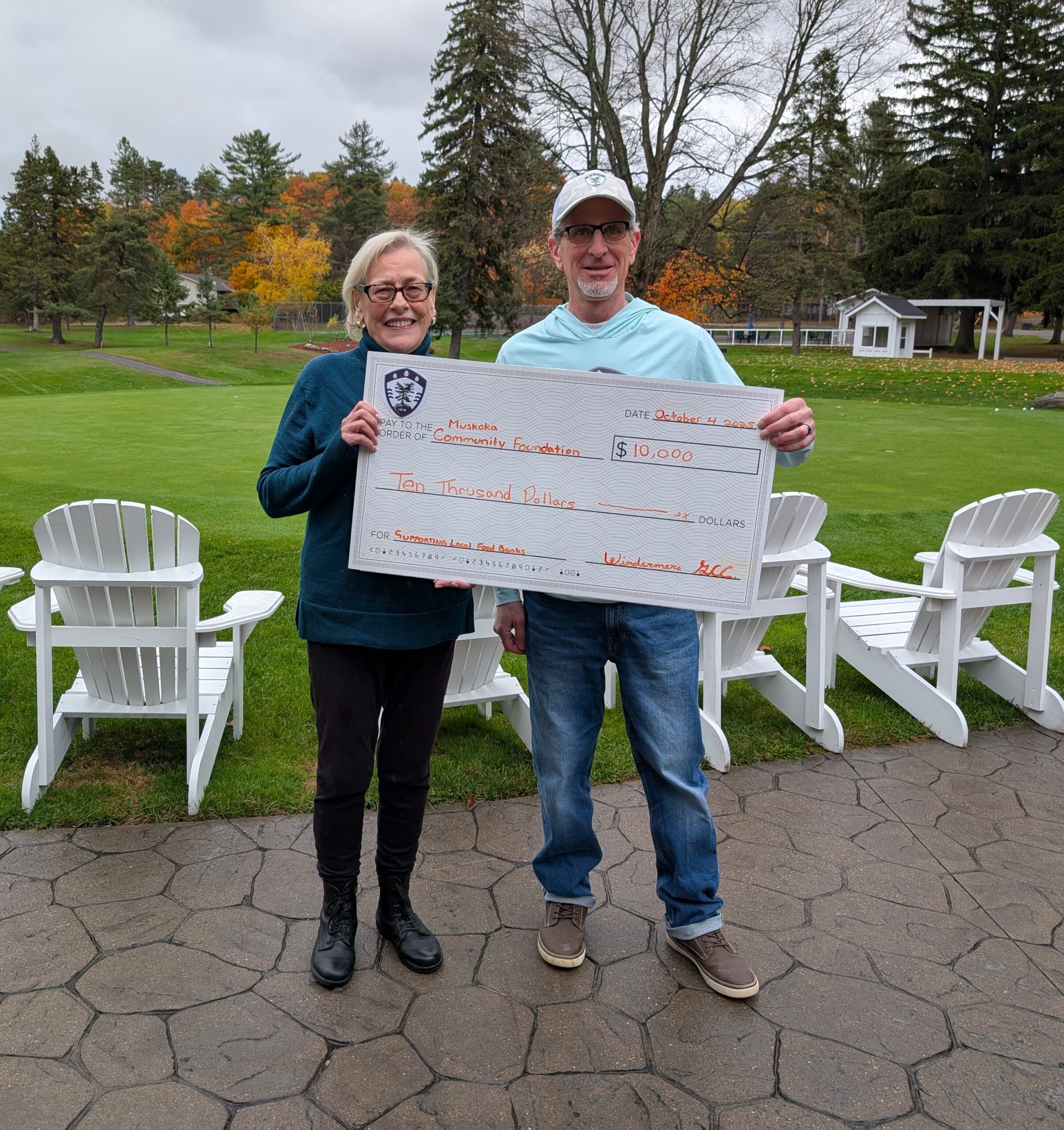 Mike Campol, General Manager of Windermere Golf & Country Club, presents a cheque for $10,000 to Mary Ellen McIntyre, Executive Director of the Muskoka Community Foundation.