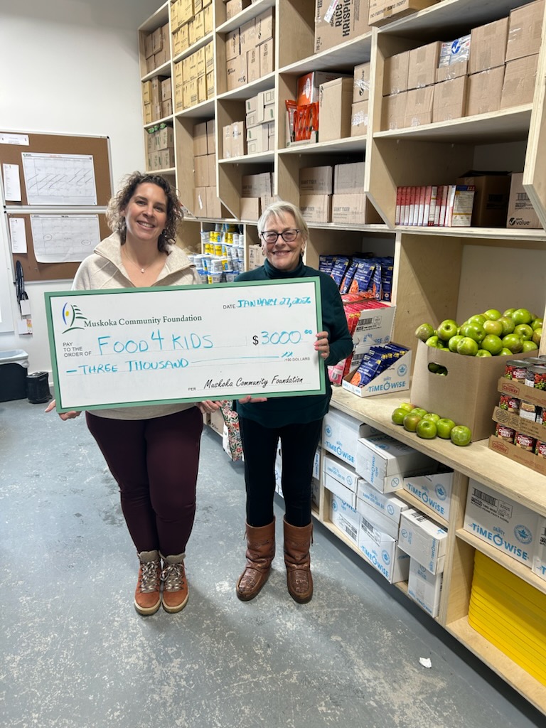 Sarah Thatcher, Executive Director of Food4Kids Muskoka (left) receives a cheque from the Lake of Bays Community Fund, presented by Mary Ellen McIntyre, Executive Director of the Muskoka Community Foundation (right).